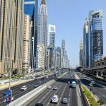 Dubai skyline along Sheikh Zayed Road showing multi-lane traffic, modern skyscrapers, and urban transport infrastructure in the UAE.