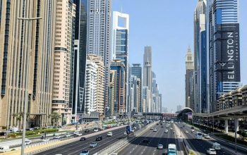 Dubai skyline along Sheikh Zayed Road showing multi-lane traffic, modern skyscrapers, and urban transport infrastructure in the UAE.