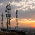 Telecommunications towers overlooking an urban area as part of national mobile communications infrastructure.