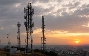 Telecommunications towers overlooking an urban area as part of national mobile communications infrastructure.
