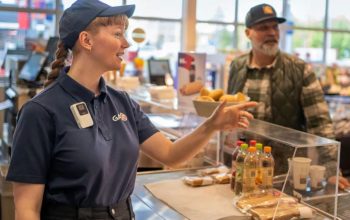 Axis W111 body worn camera worn by a retail employee assisting a customer