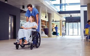 Healthcare staff using an integrated IP public address and emergency communication system in a modern hospital