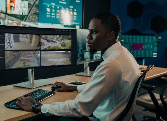 Security operator using Genetec video management software in a surveillance control room