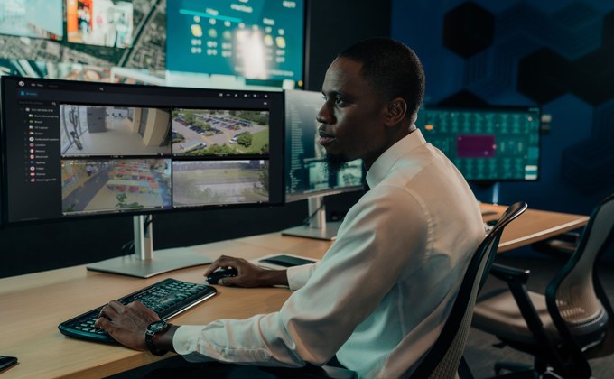 Security operator using Genetec video management software in a surveillance control room
